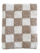 Textured checkered rug in beige and white, featuring alternating squares for a cozy, stylish accent.