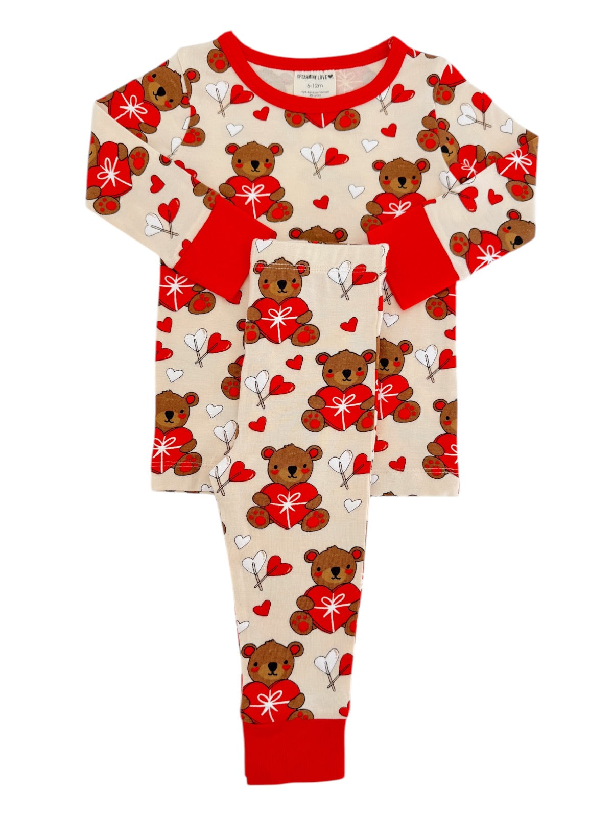 Children's pajamas featuring teddy bears, hearts, and arrows in red and beige. Cute and cozy for sleepwear.