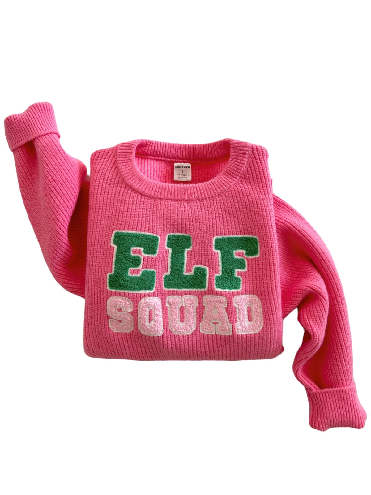 Bright pink sweater with "ELF SQUAD" in green and white letters, featuring long sleeves.