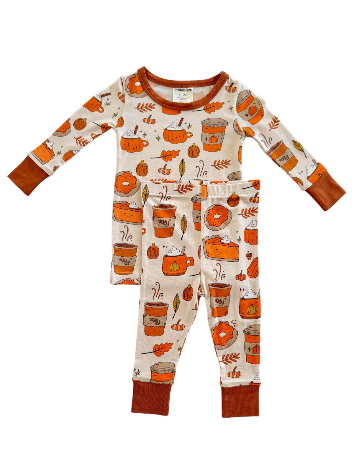 Kids' autumn-themed pajamas featuring pumpkins, cups, and leaves in orange and brown colors.