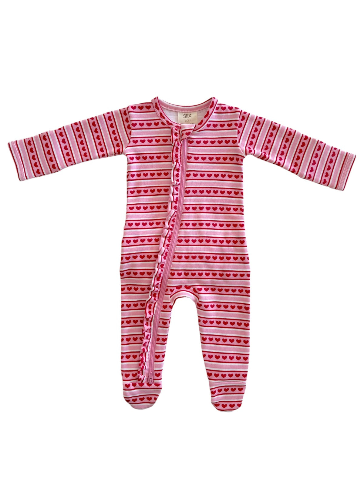 Pink baby onesie with red heart patterns, featuring long sleeves and a front zipper. Ideal for cozy comfort.
