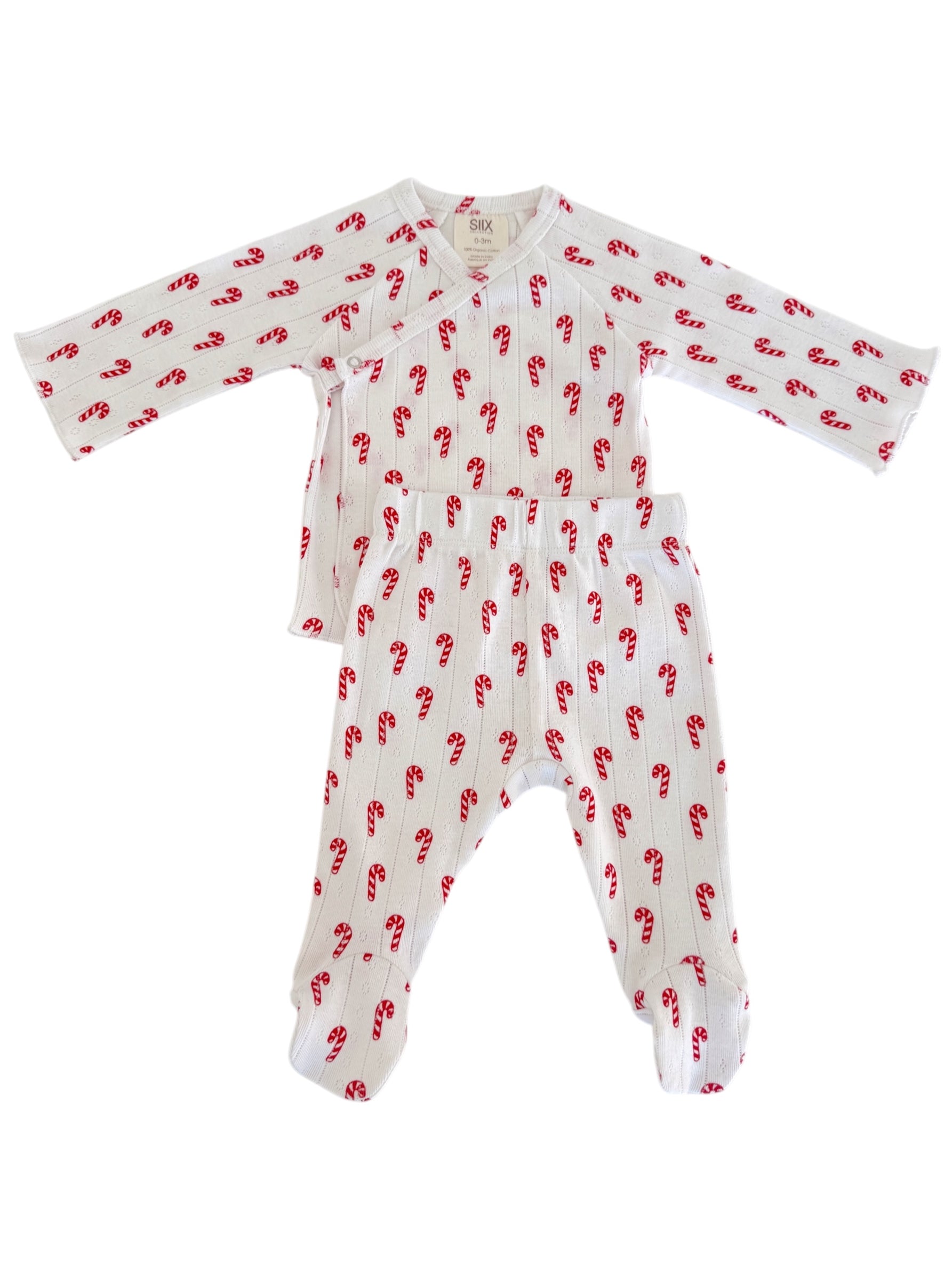 White baby pajama set with red candy cane pattern. Includes long-sleeve top and footed pants.