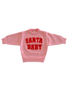 Oversized pink sweater with the text "SANTA BABY" in bold red letters. Perfect for festive occasions.