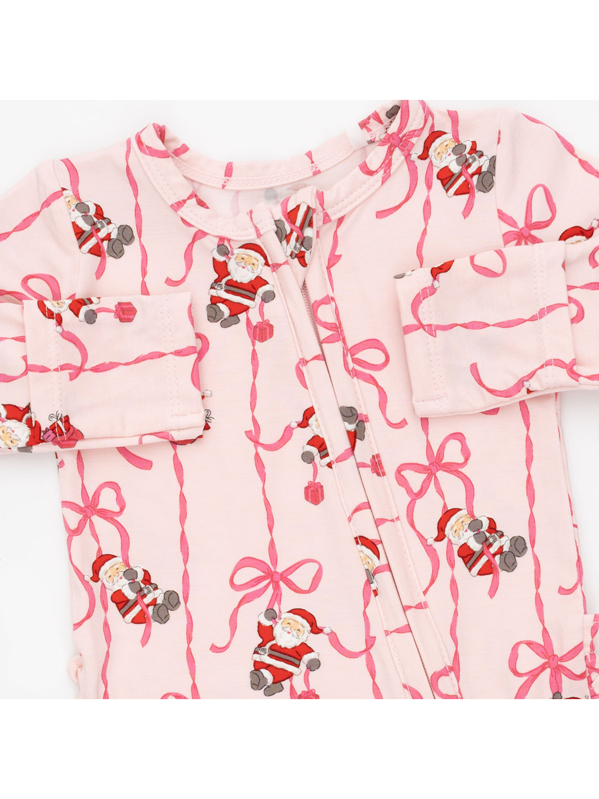 Pink baby onesie with Santa Claus and candy cane bow patterns. Ideal for festive occasions.