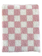 Pink and white checkered soft bath rug with a fluffy texture.