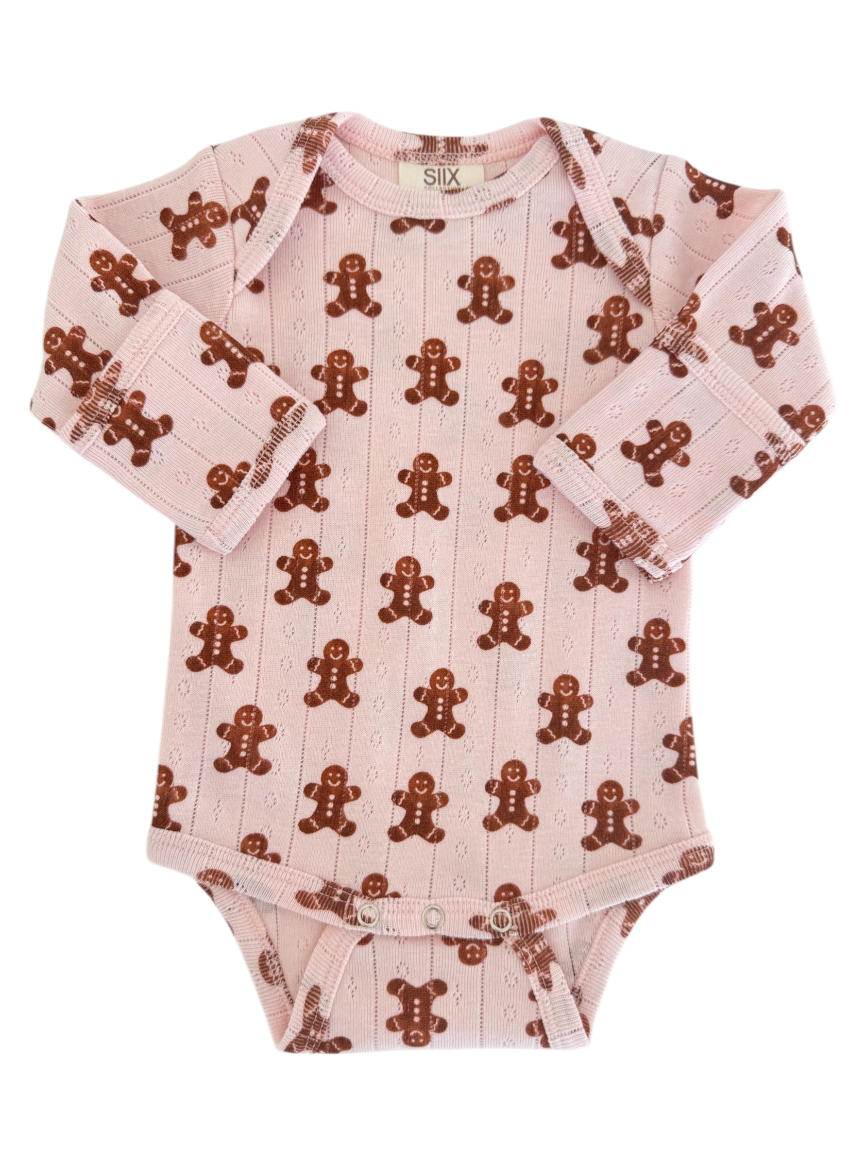 Pink baby onesie with a gingerbread man pattern on soft fabric. Long sleeves and snap closures at the bottom.