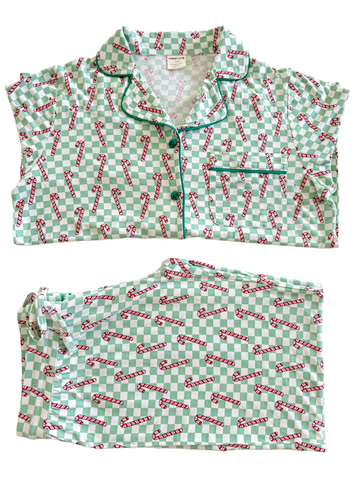 Mint green pajamas with a candy cane pattern, featuring a short-sleeve top and matching pants laid out flat.