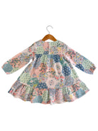 Long-sleeve floral dress on a hanger, featuring a colorful patchwork design with ruffled hem.