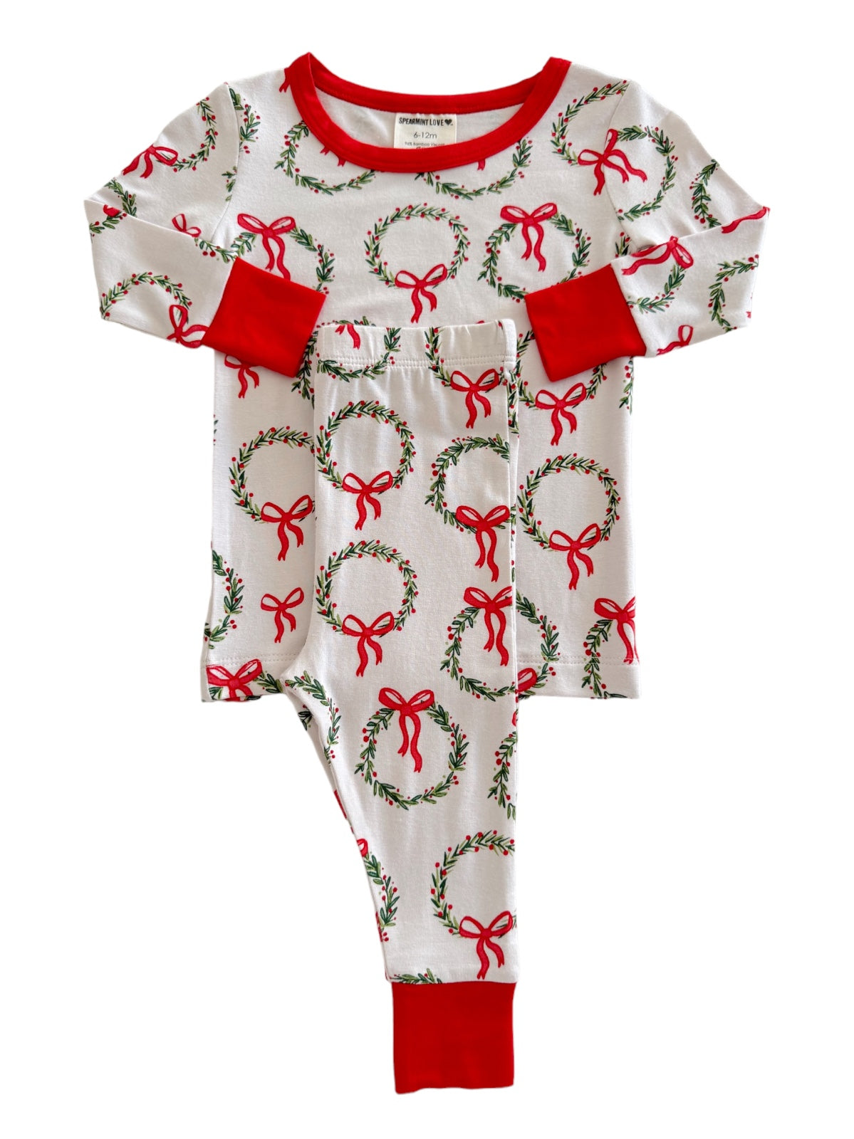 Red and white holiday-themed pajama set with wreath and bow patterns.