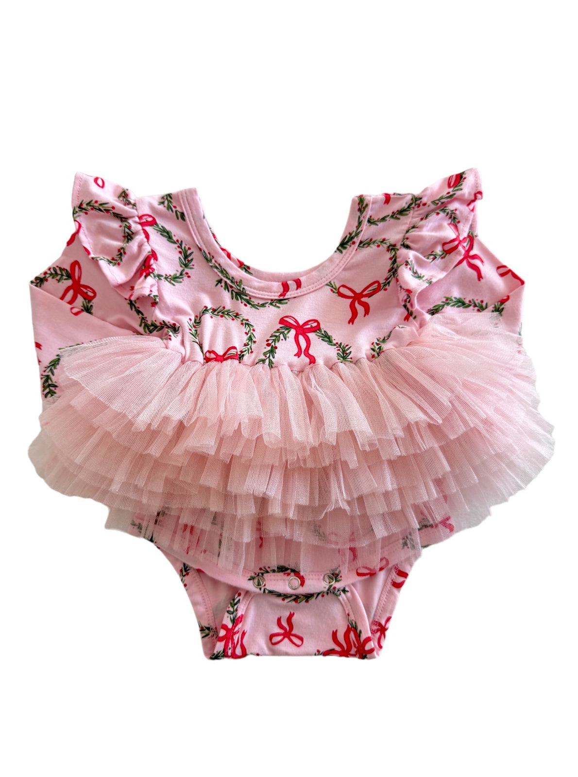 Pink baby onesie with ruffled sleeves and a tulle skirt, decorated with green foliage and red bows.