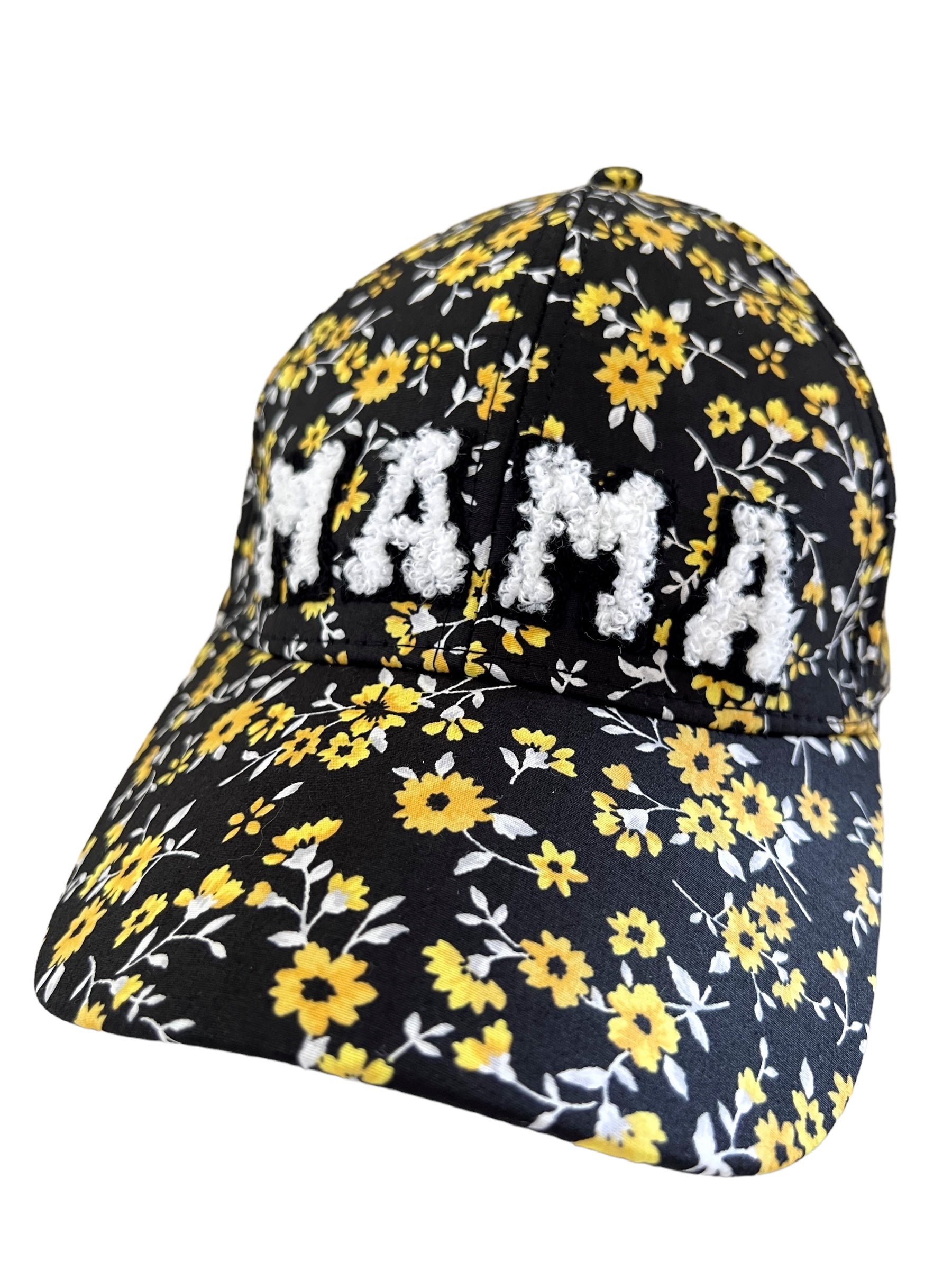 Black floral cap with yellow flowers and "MAMA" embroidered in white.