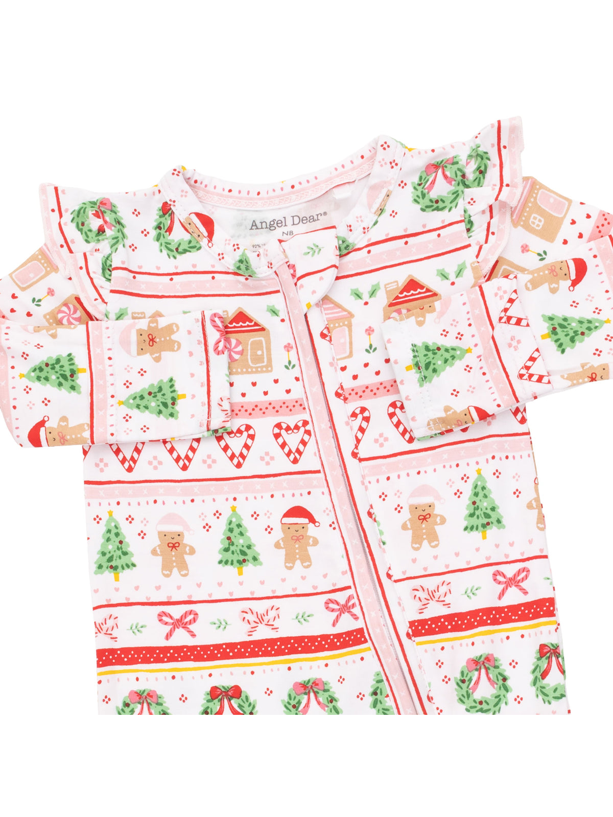 Christmas-themed children's pajamas with gingerbread men, trees, and candy canes on a pink background.