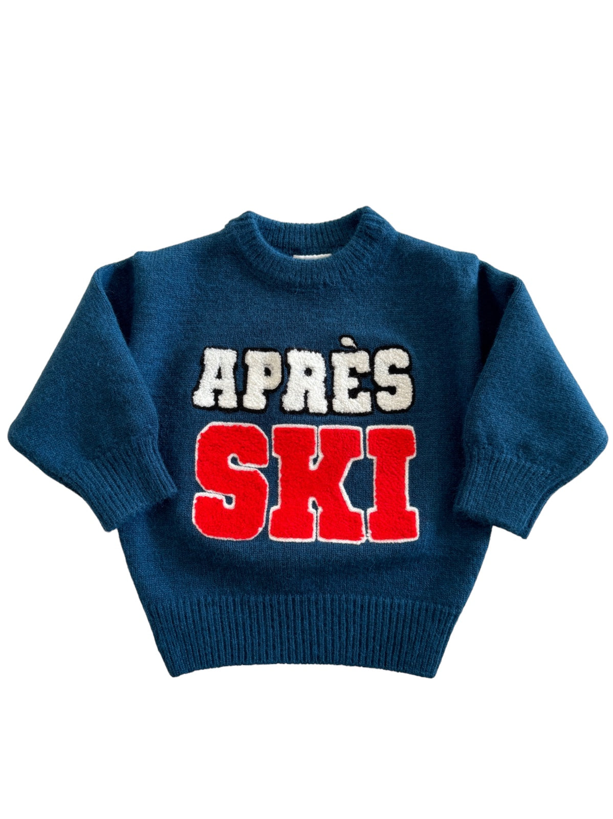Navy blue sweater with "APRÈS SKI" text in red and white, featuring a cozy design ideal for winter wear.
