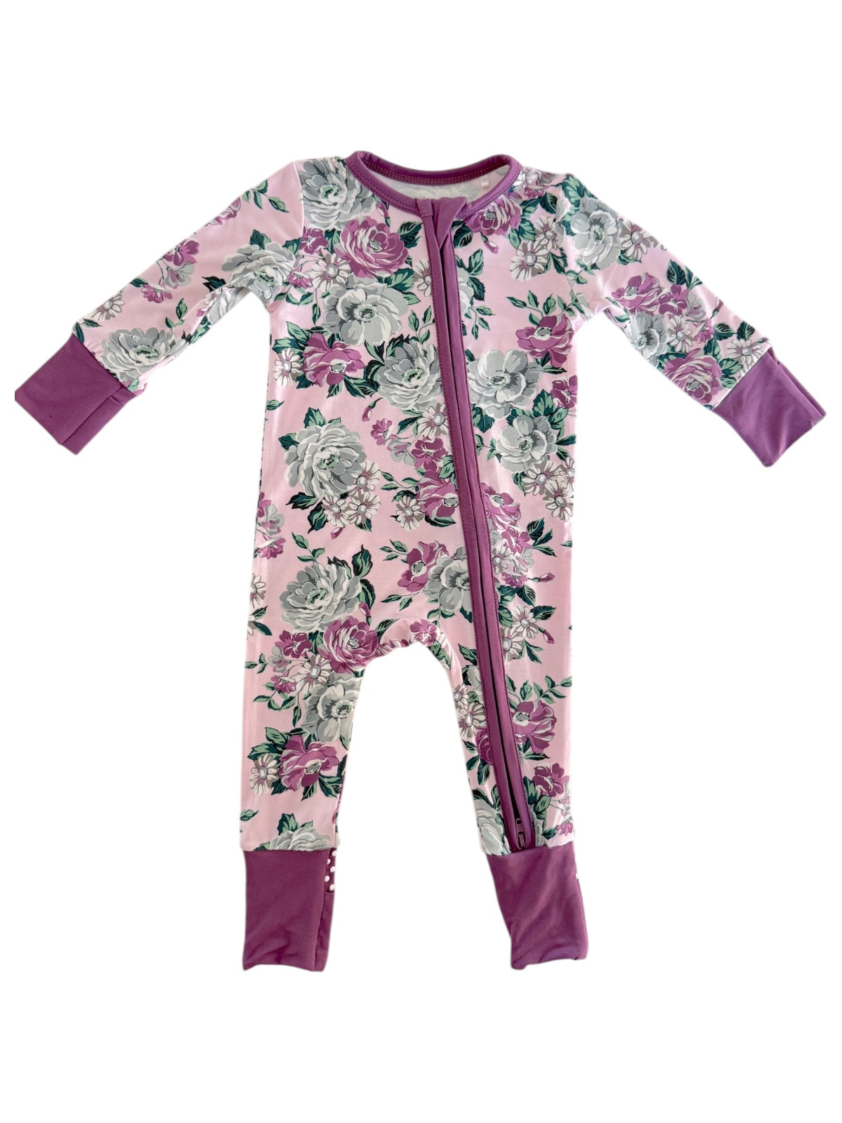 Floral baby onesie in pink with long sleeves and a zipper, featuring purple accents on the cuffs and feet.