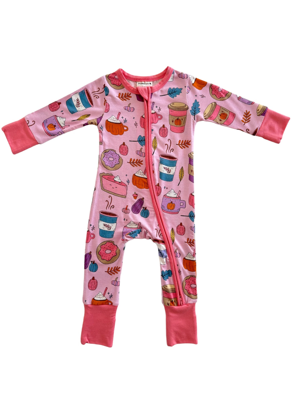 Pink children's pajama romper featuring colorful food and drink illustrations, including donuts and pumpkins.