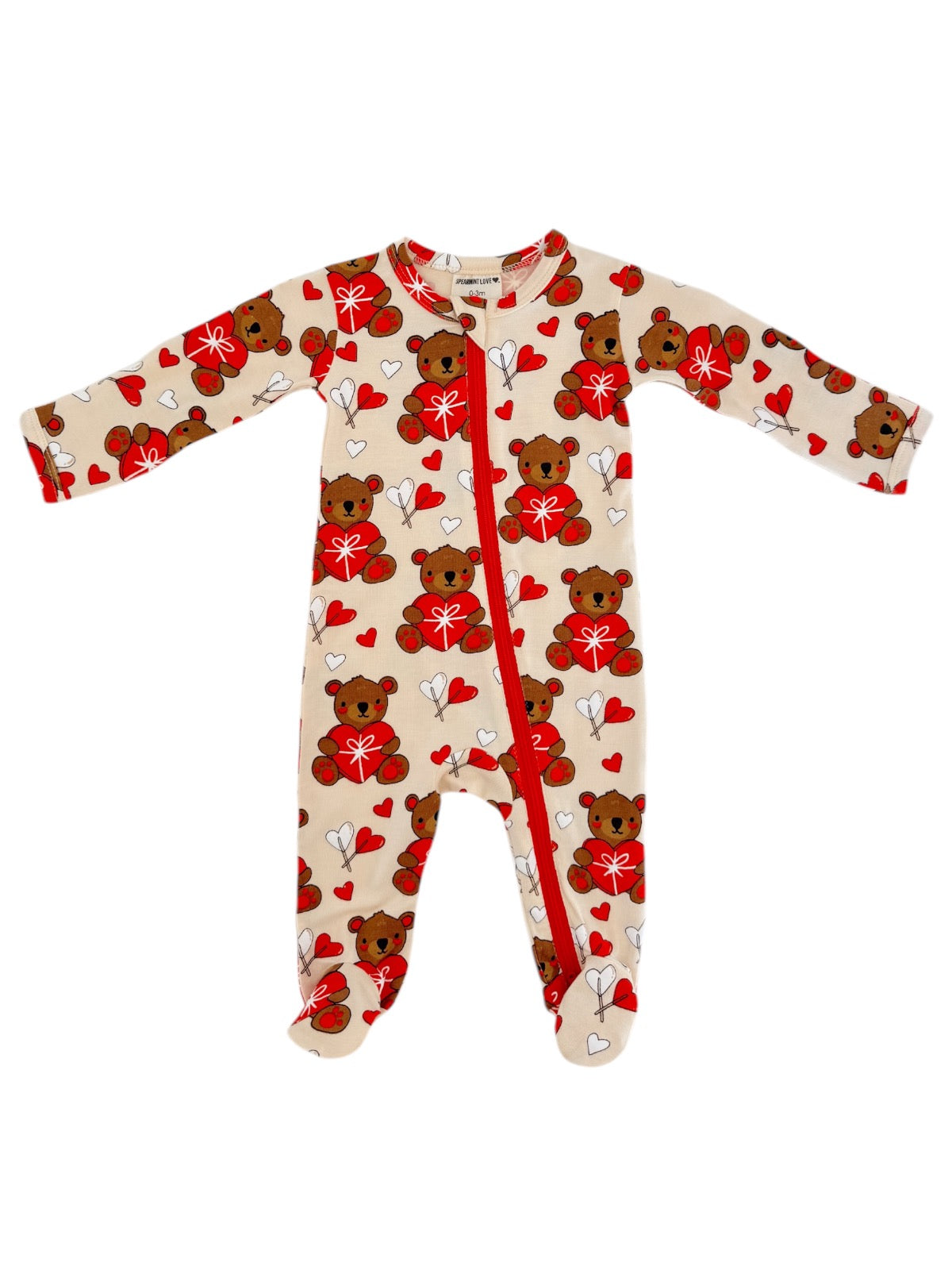 Cream onesie with teddy bears and hearts, featuring long sleeves and a front zipper. Ideal for infants.