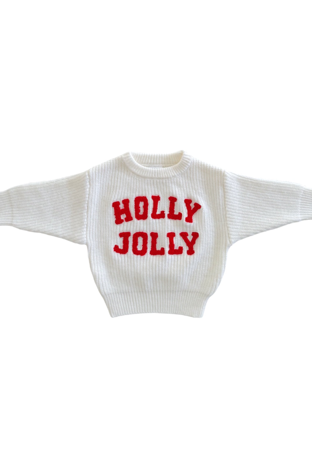 White sweater with red "HOLLY JOLLY" text, featuring a cozy, oversized design suitable for festive occasions.