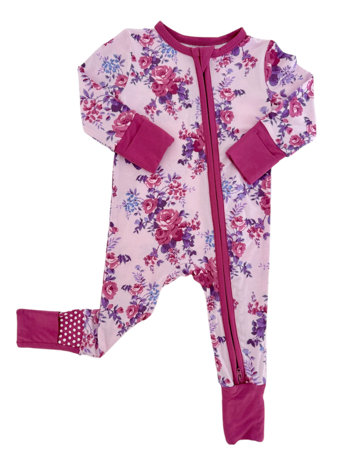 Floral-patterned children's onesie in pink and purple with a front zip and contrasting sleeves.