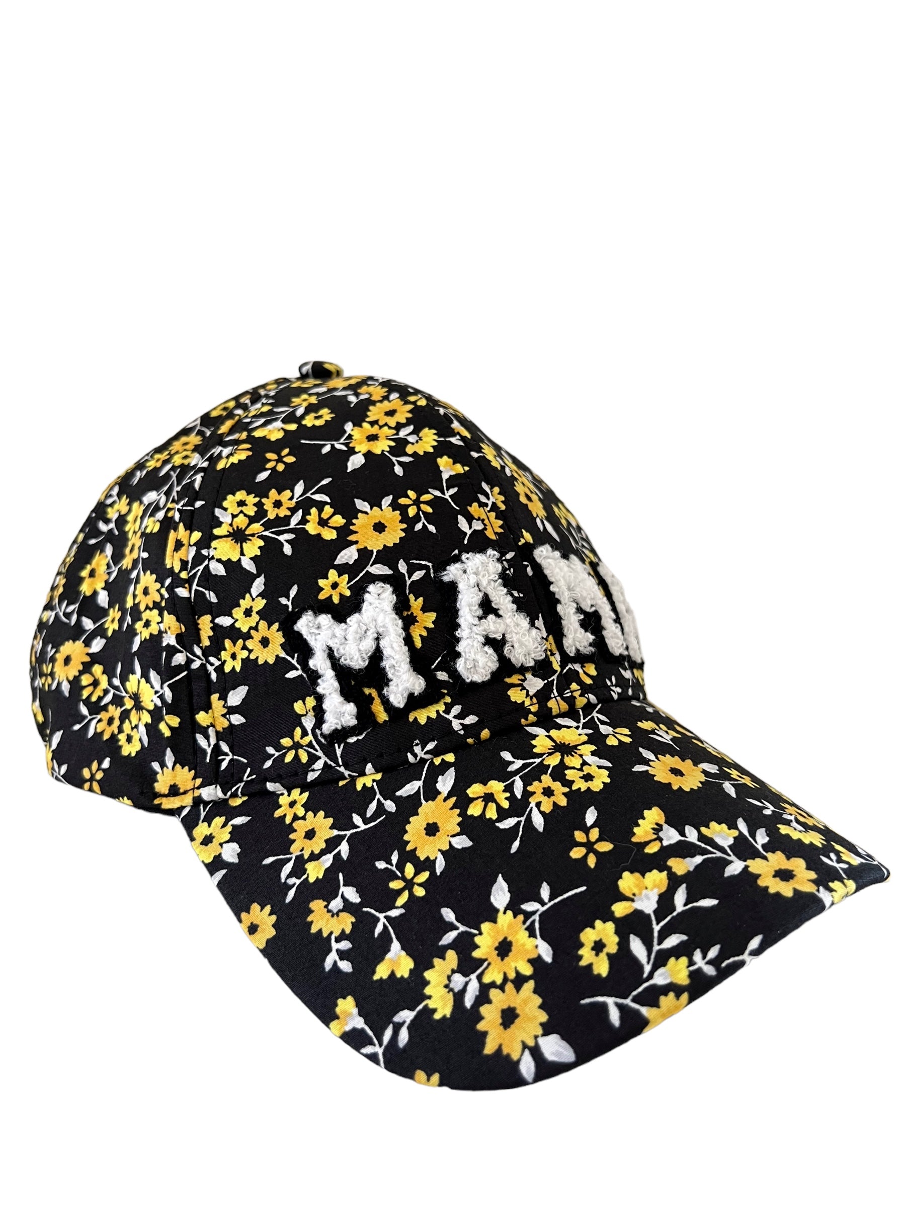 Floral black cap with "MAMA" in white, featuring yellow and white flowers on the fabric.
