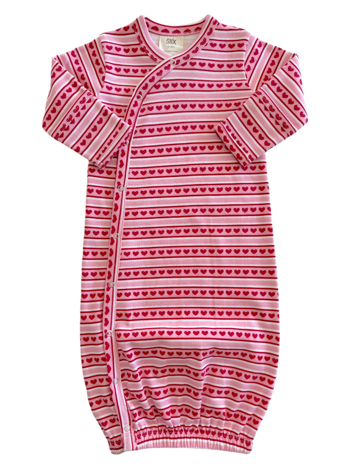 Pink infant sleeper with heart patterns and striped design, featuring long sleeves and snap button closures.