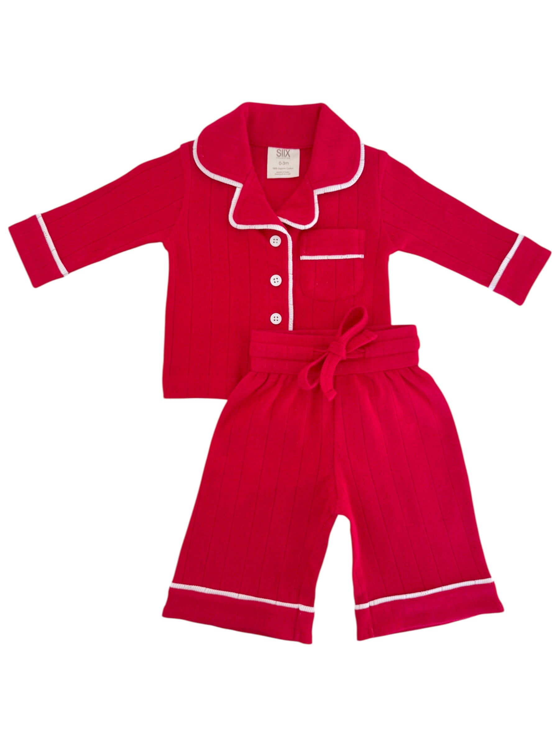 Bright red children's pajamas with white trim, featuring a collared top and matching shorts.