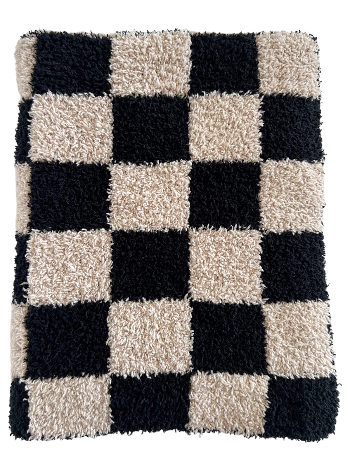 Black and beige shaggy checkered rug with alternating squares.