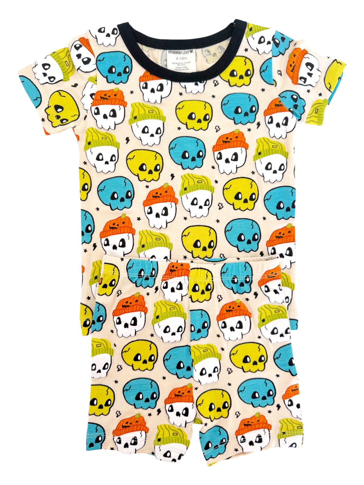 Colorful toddler pajamas featuring playful skull and cupcake designs in blue, yellow, orange, and green.