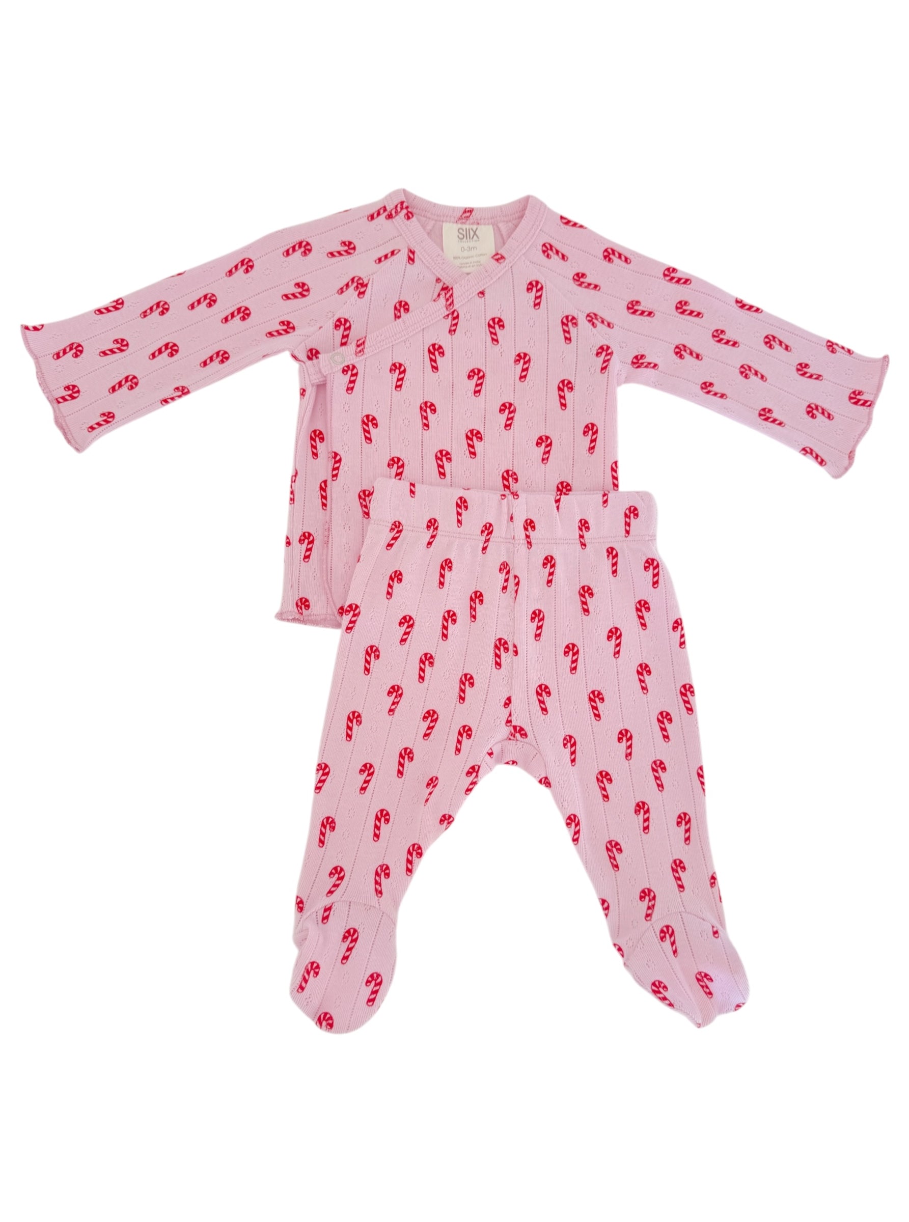 Baby pajama set with long sleeves and pants, featuring a pink color and red candy cane pattern.