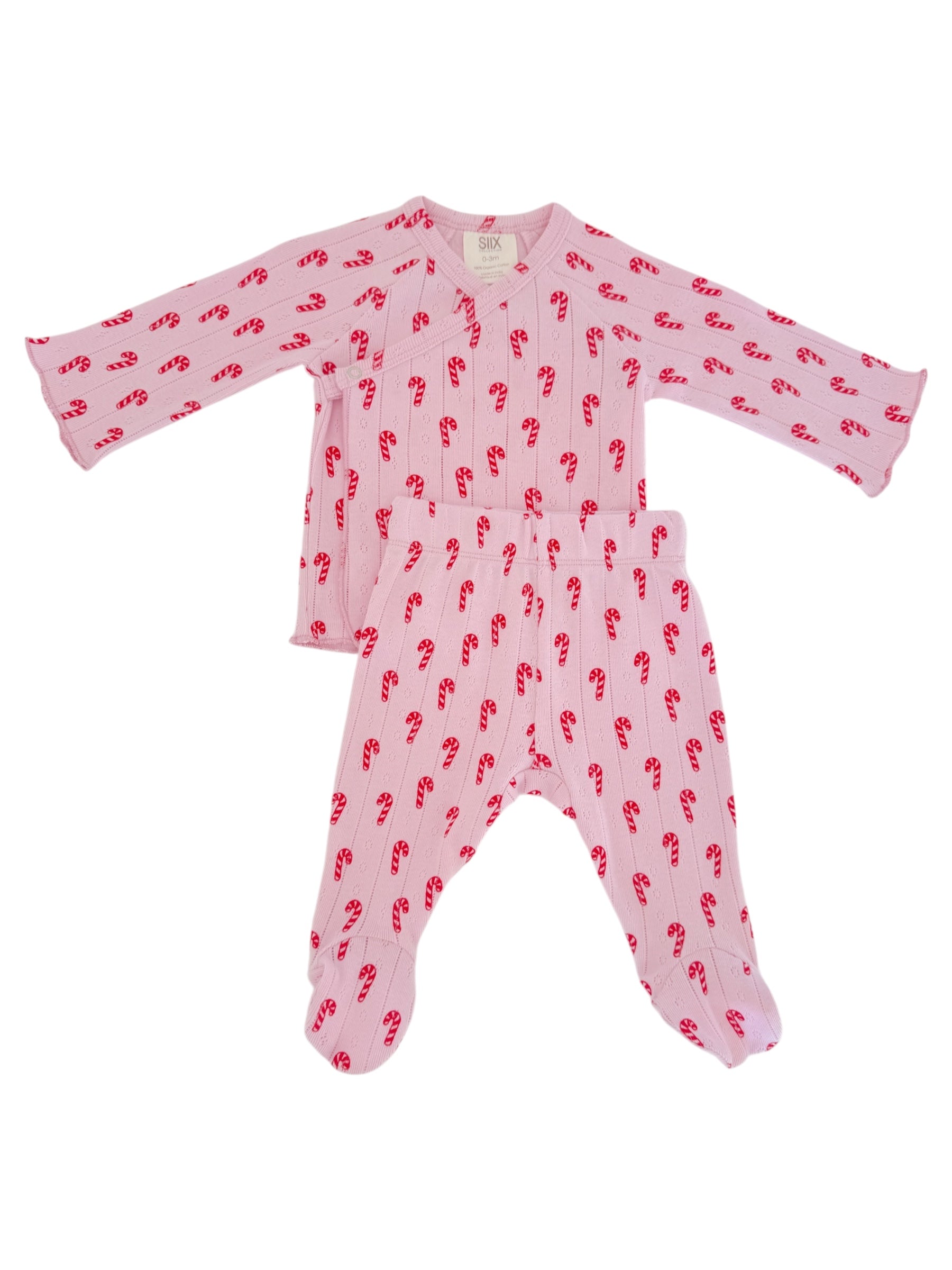 Baby pajama set with long sleeves and pants, featuring a pink color and red candy cane pattern.