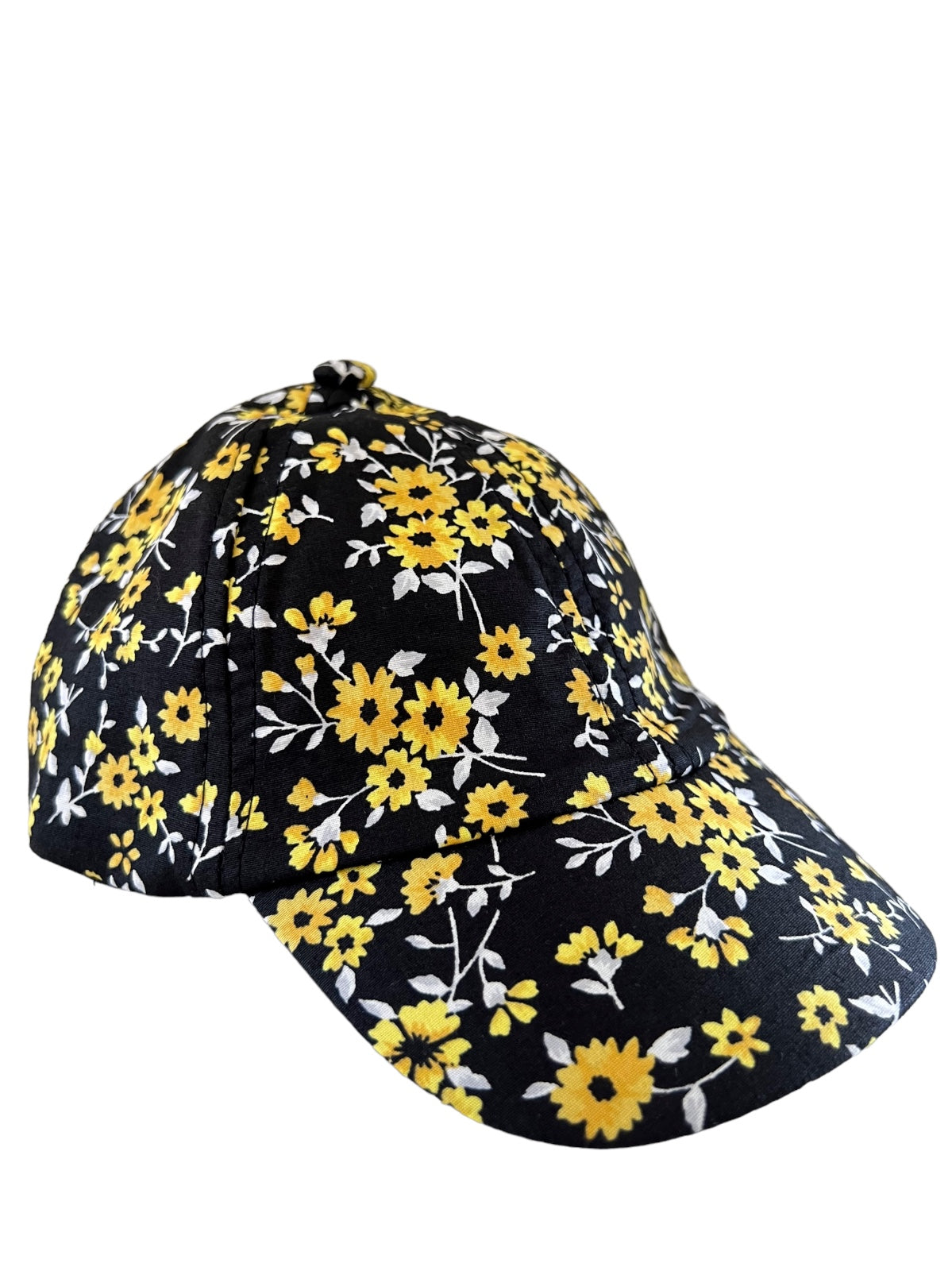 Black baseball cap with yellow and white floral pattern, angled view.