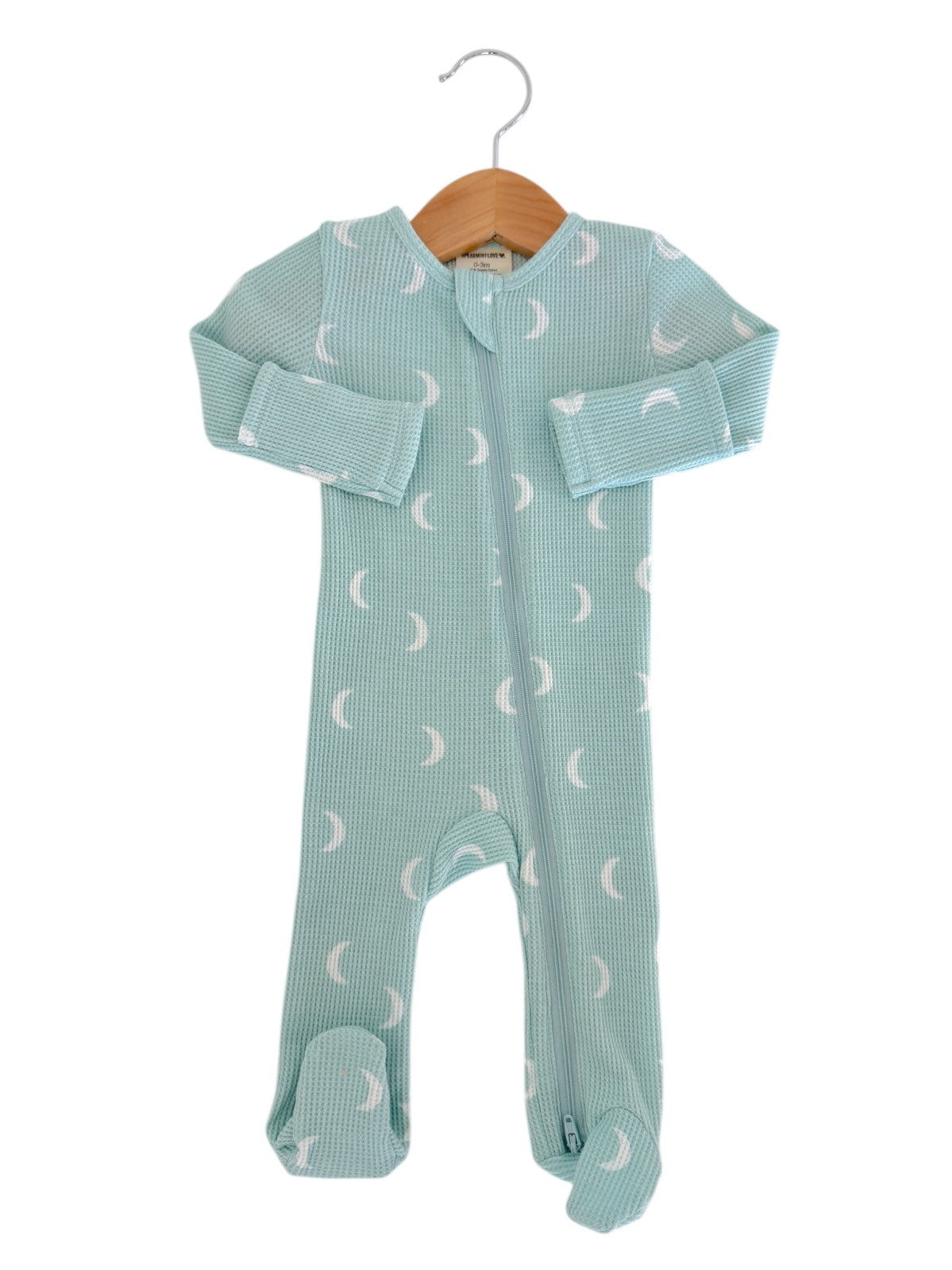 Light blue baby onesie with crescent moon pattern, hung on a wooden hanger against a white background.