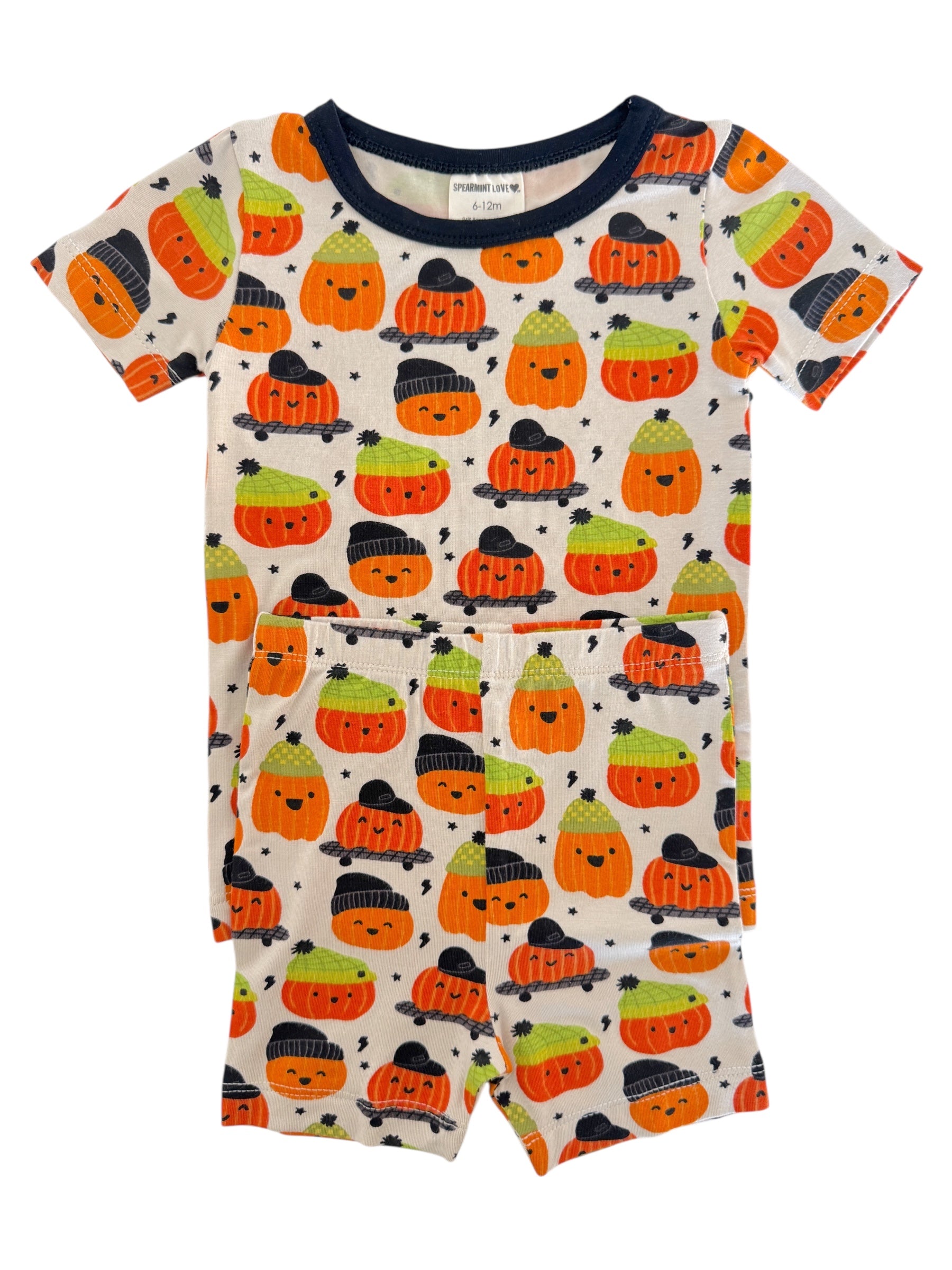 Children's Halloween-themed pajamas featuring smiling pumpkins in various colors and styles.