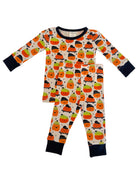 Children's pajama set featuring colorful smiling pumpkins on a cream background with navy blue trim and cuffs.