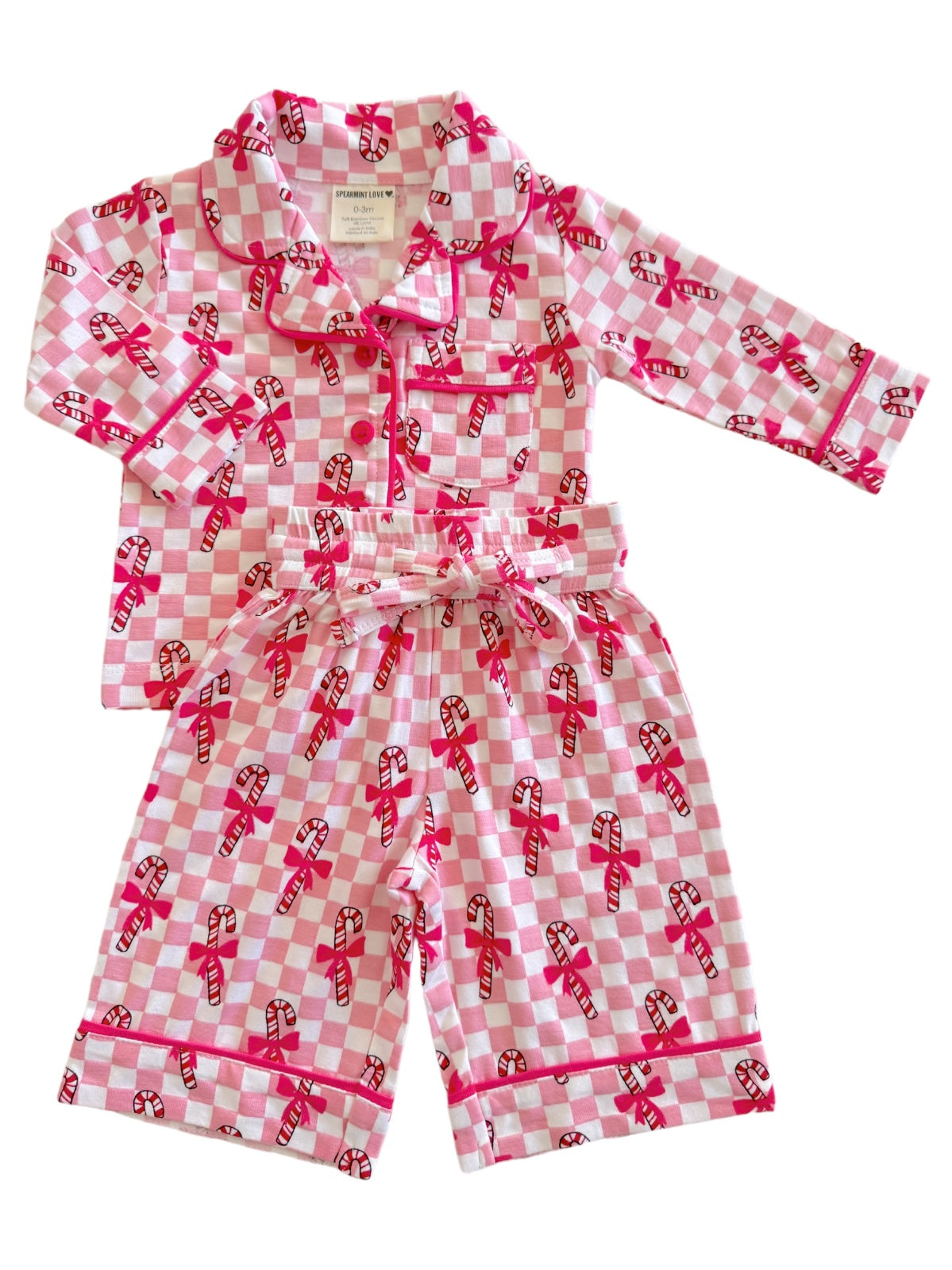 Pink checkered pajama set with candy cane patterns and bows, featuring a button-up top and drawstring shorts.