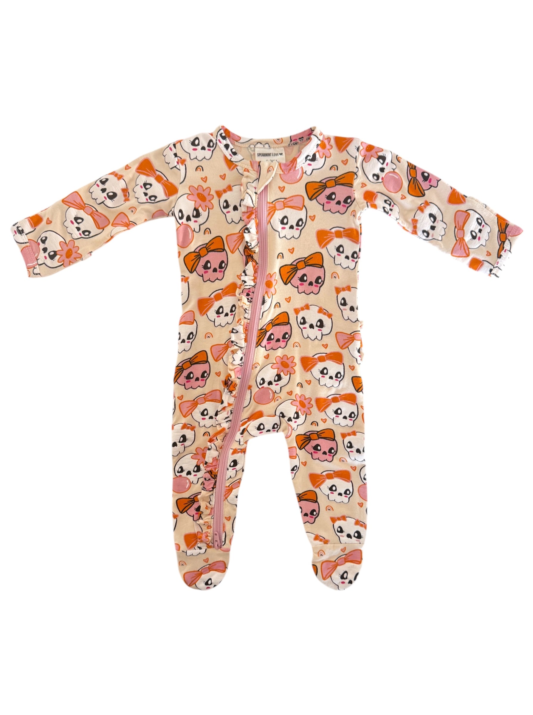 Infant onesie with a playful skull and bow pattern in pink and orange colors, featuring a full front zipper.