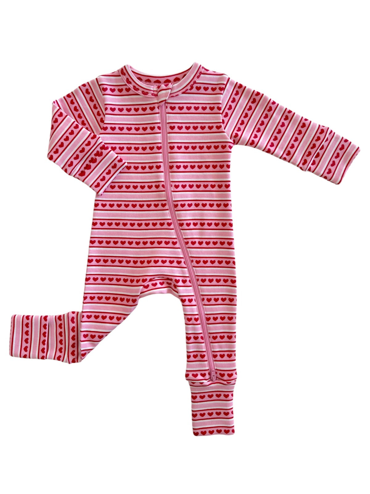 Pink infant onesie with red heart patterns and long sleeves, featuring a front zipper closure.