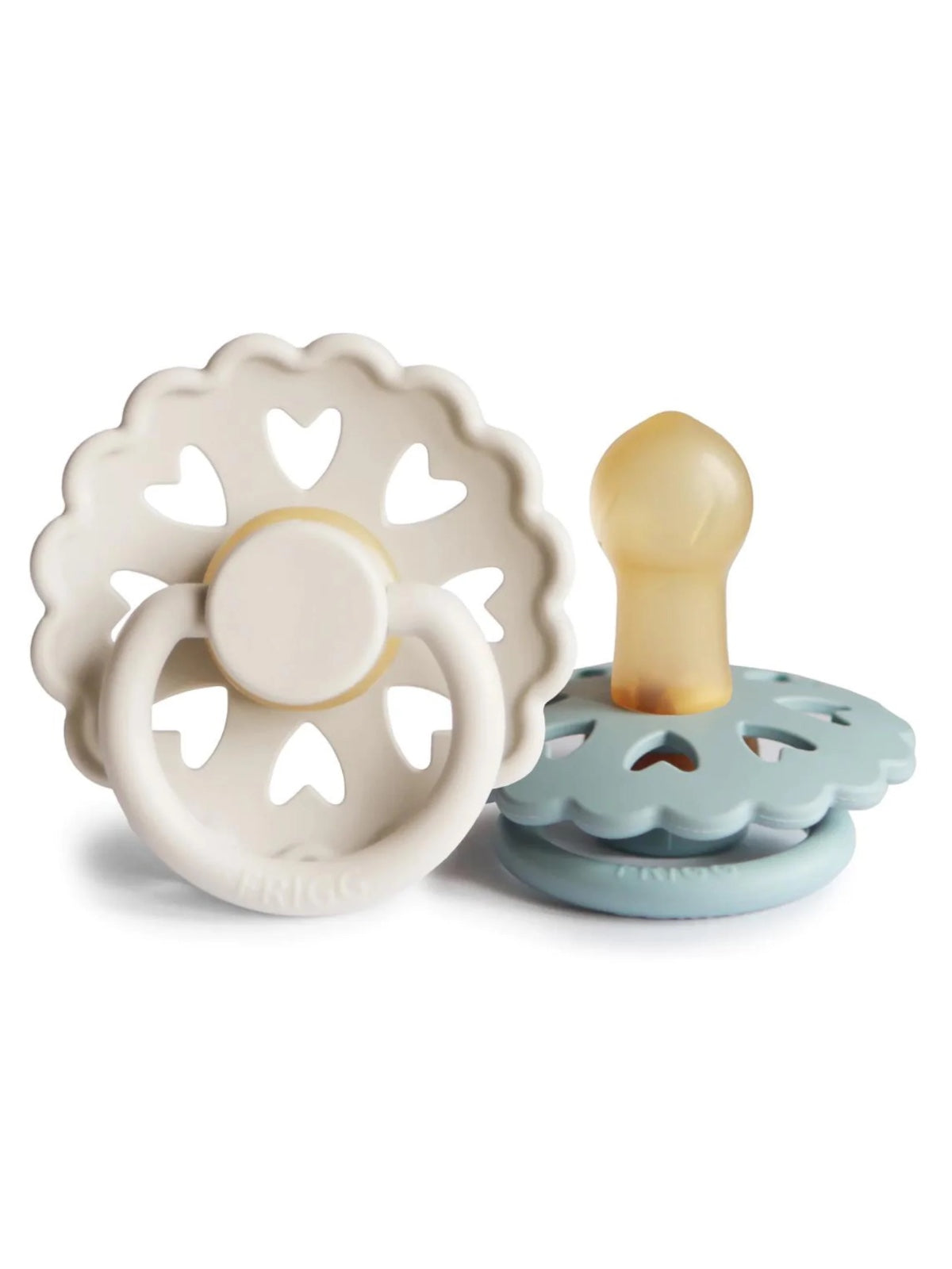 Two baby pacifiers with heart-shaped designs, one in pale beige and the other in light blue.