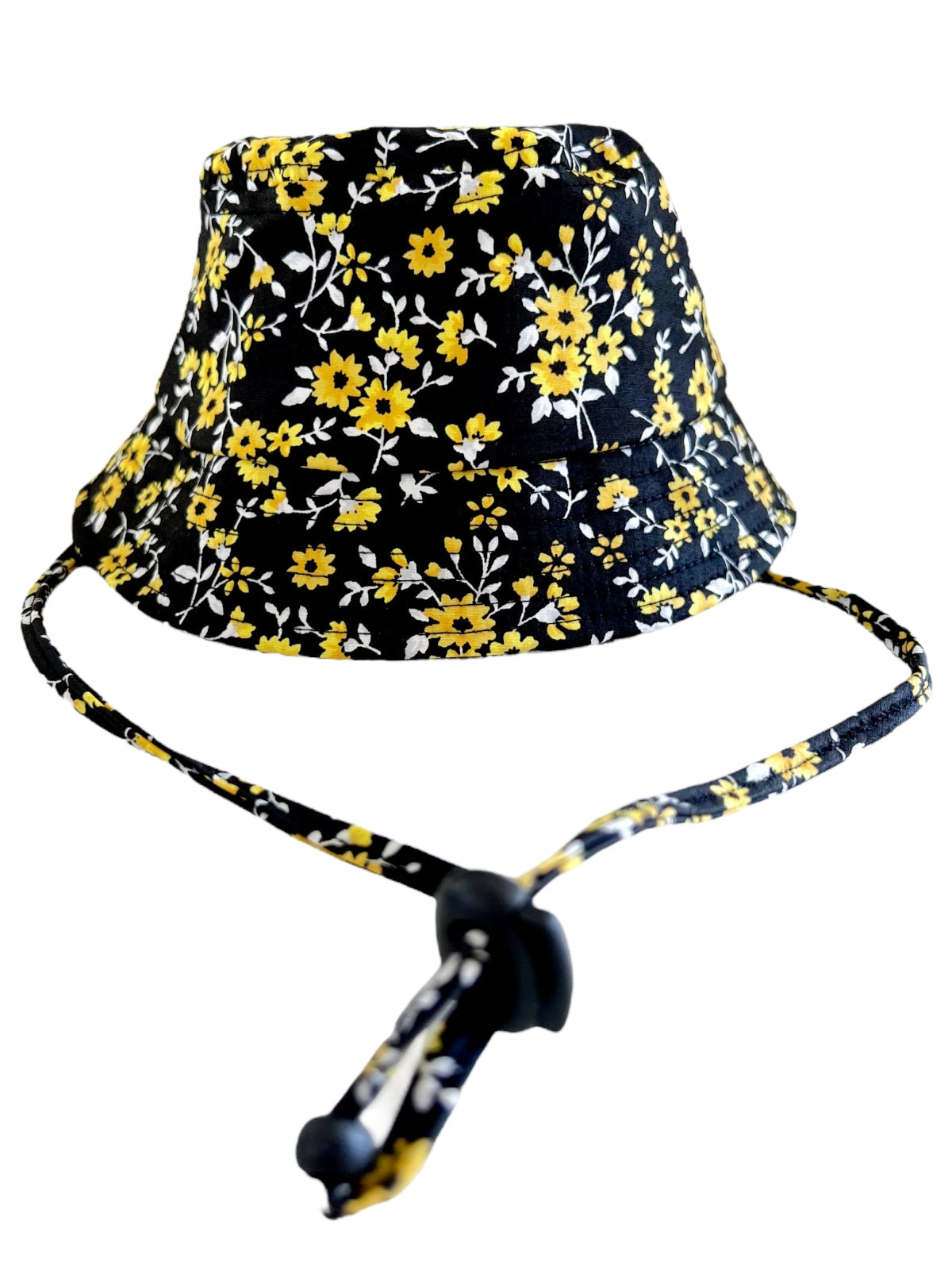 Black bucket hat with yellow and white floral pattern and adjustable chin strap.