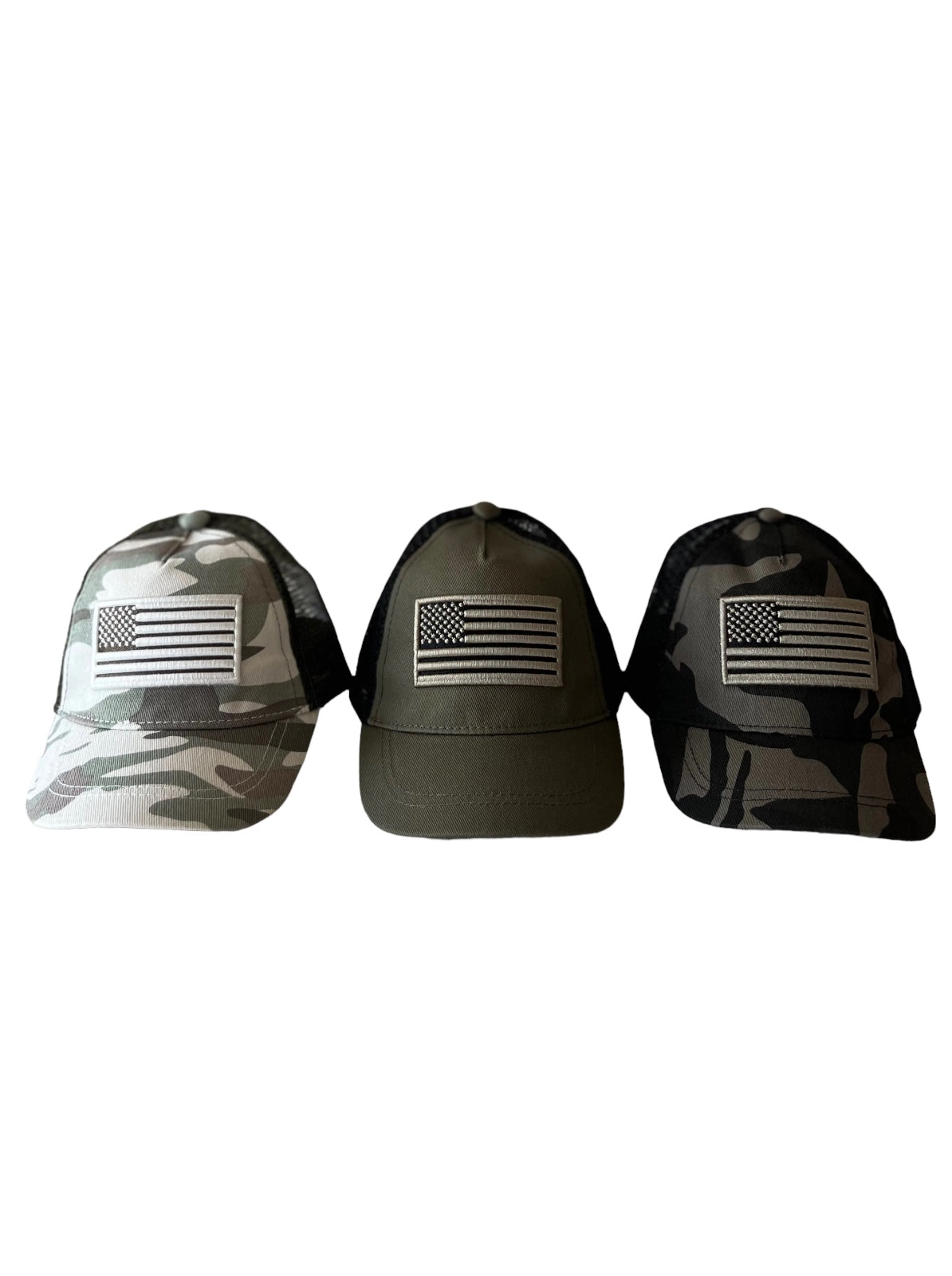Three baseball caps in camouflage and solid colors, each featuring an American flag patch on the front.