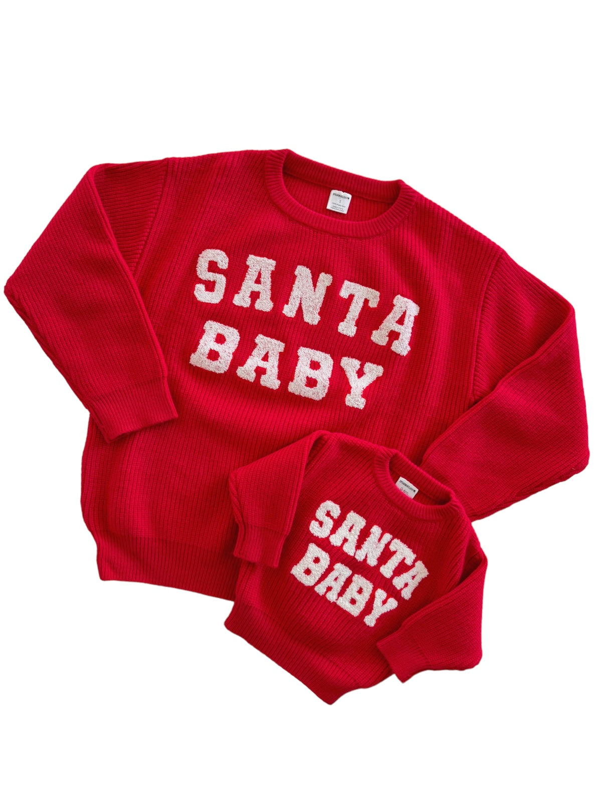 Red "Santa Baby" matching sweaters for adults and children, featuring fluffy white lettering.