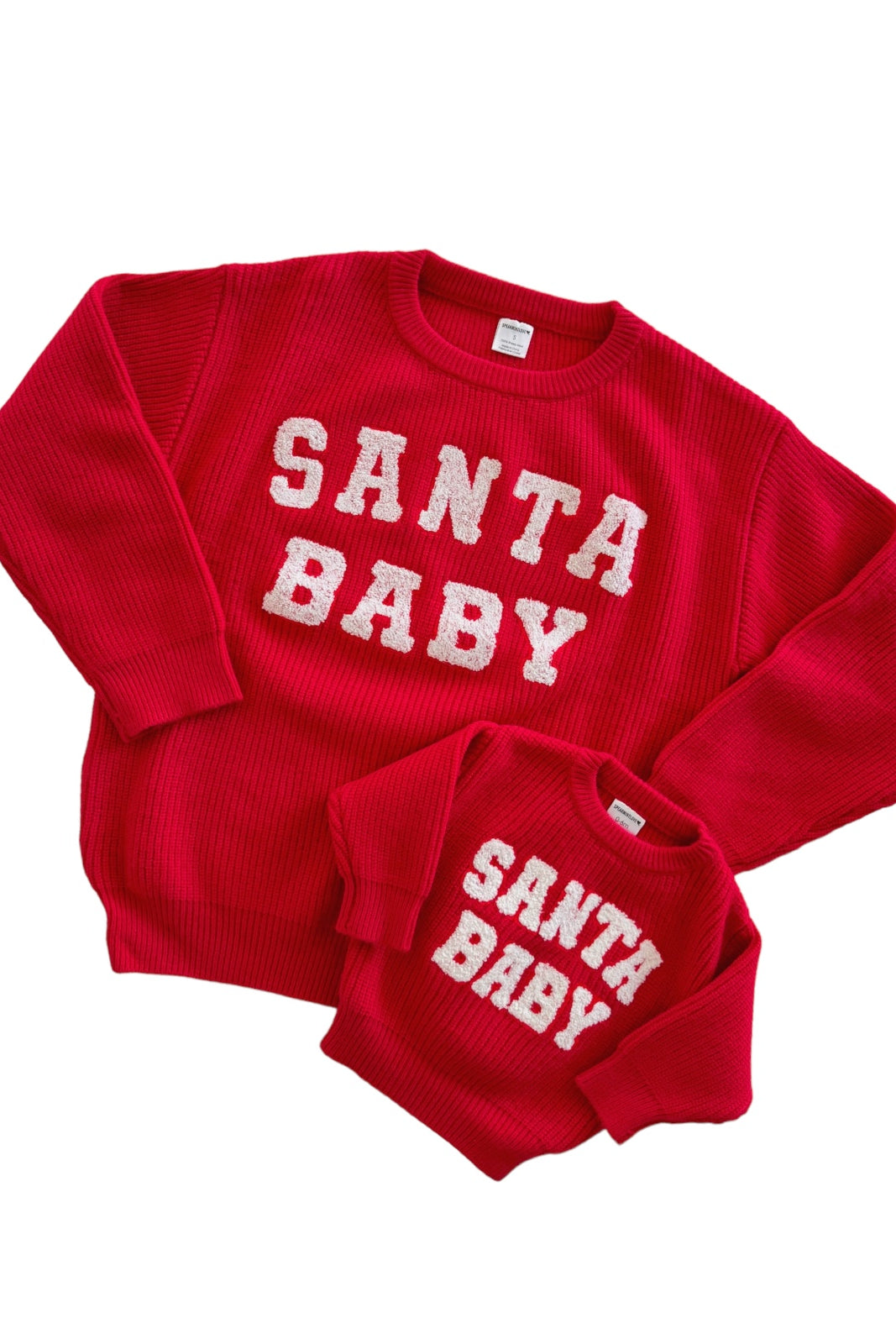 Red "Santa Baby" matching sweaters for adults and children, featuring fluffy white lettering.
