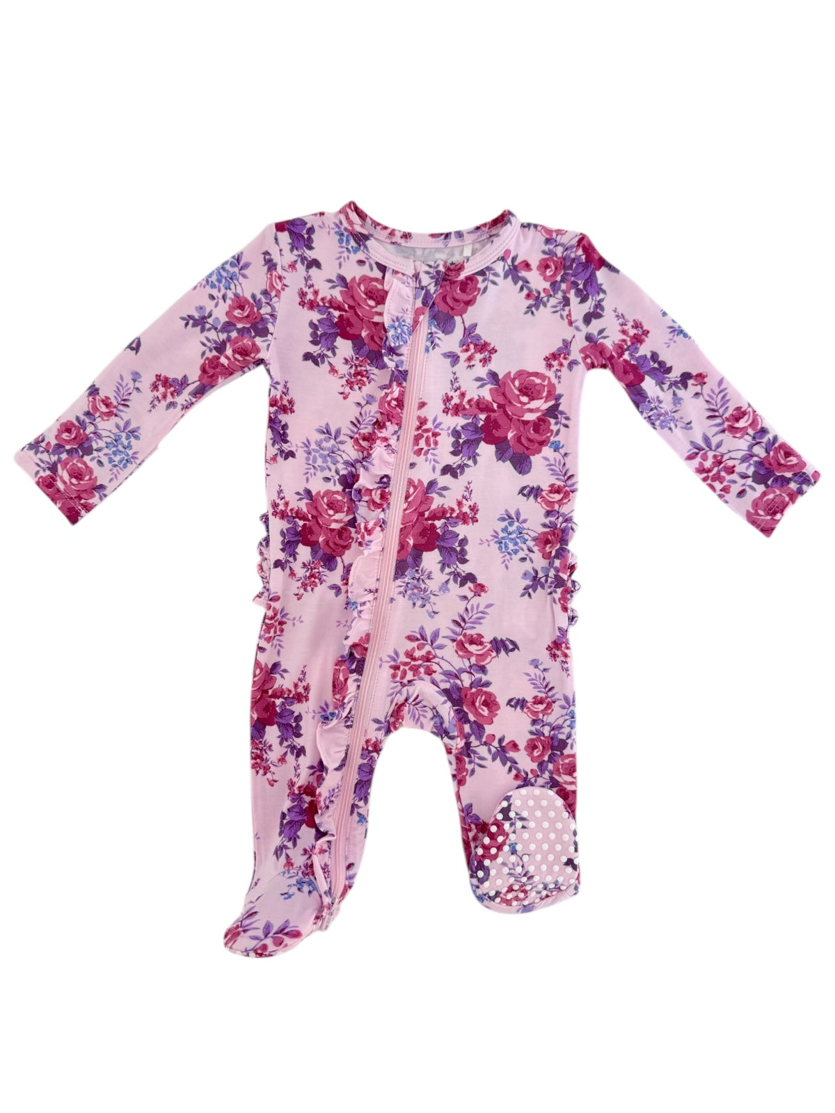 Pink floral baby onesie with long sleeves and a front zipper, featuring ruffled edges and a polka dot foot.