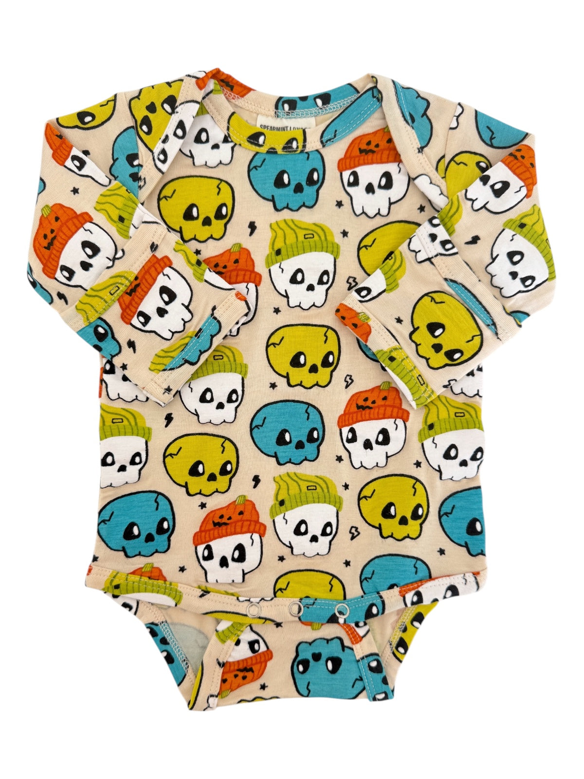 Colorful baby onesie featuring playful skull designs in various colors and hats.