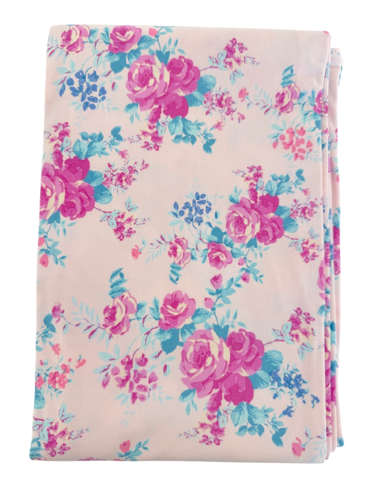 Floral fabric with pink and blue roses on a light background, folded neatly. Ideal for crafting or home decor.