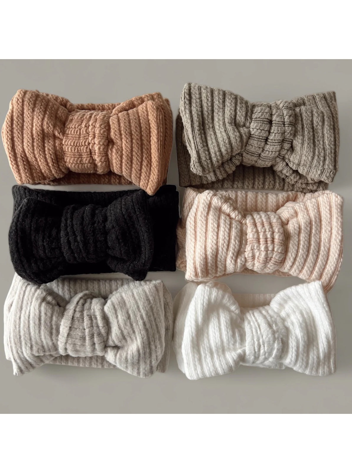Six textured headbands in various colors: pink, black, gray, white, and striped designs.