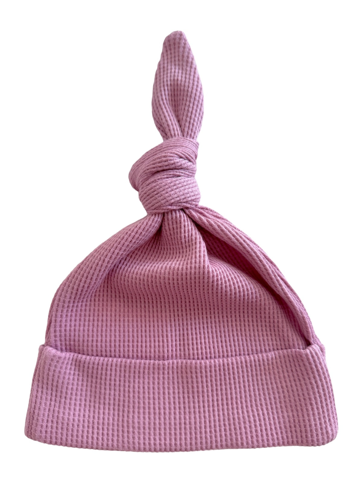 Pink knotted baby hat with a textured fabric, perfect for infants and newborns.