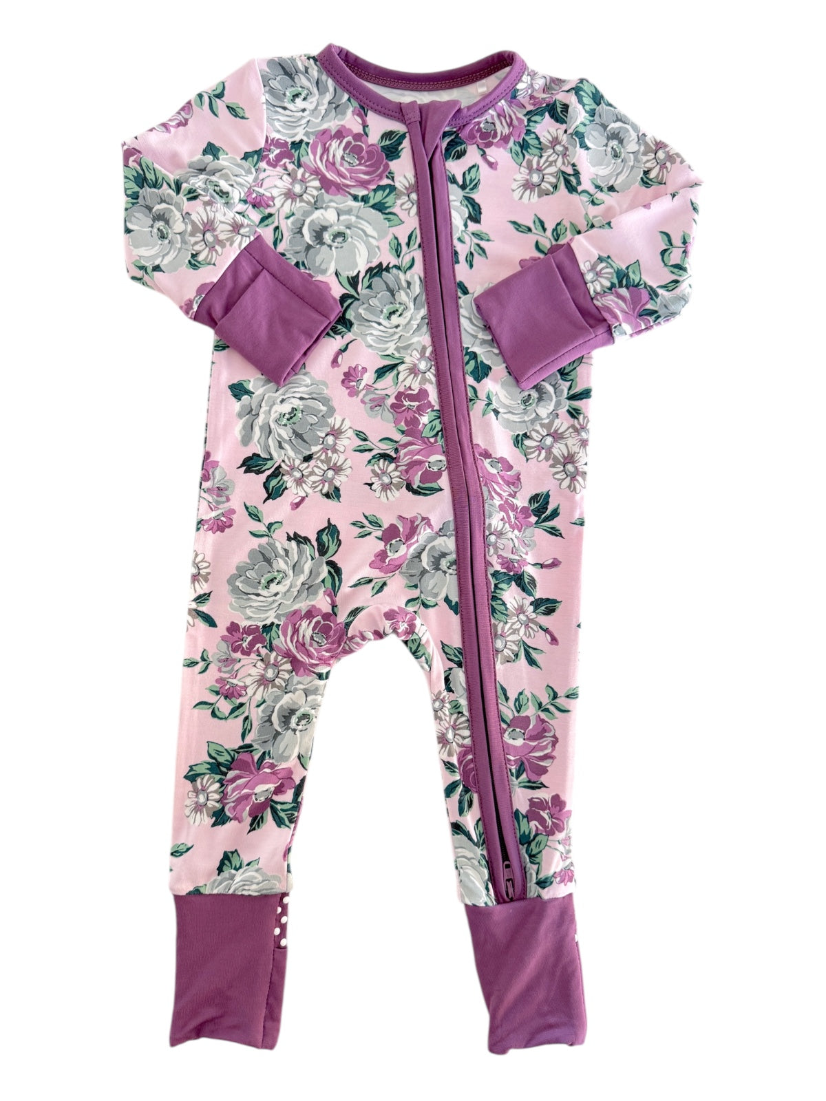 Floral-patterned children’s onesie in pink with purple accents and a front zipper.