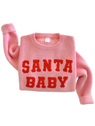Pink sweater with "SANTA BABY" in bold red letters across the front.