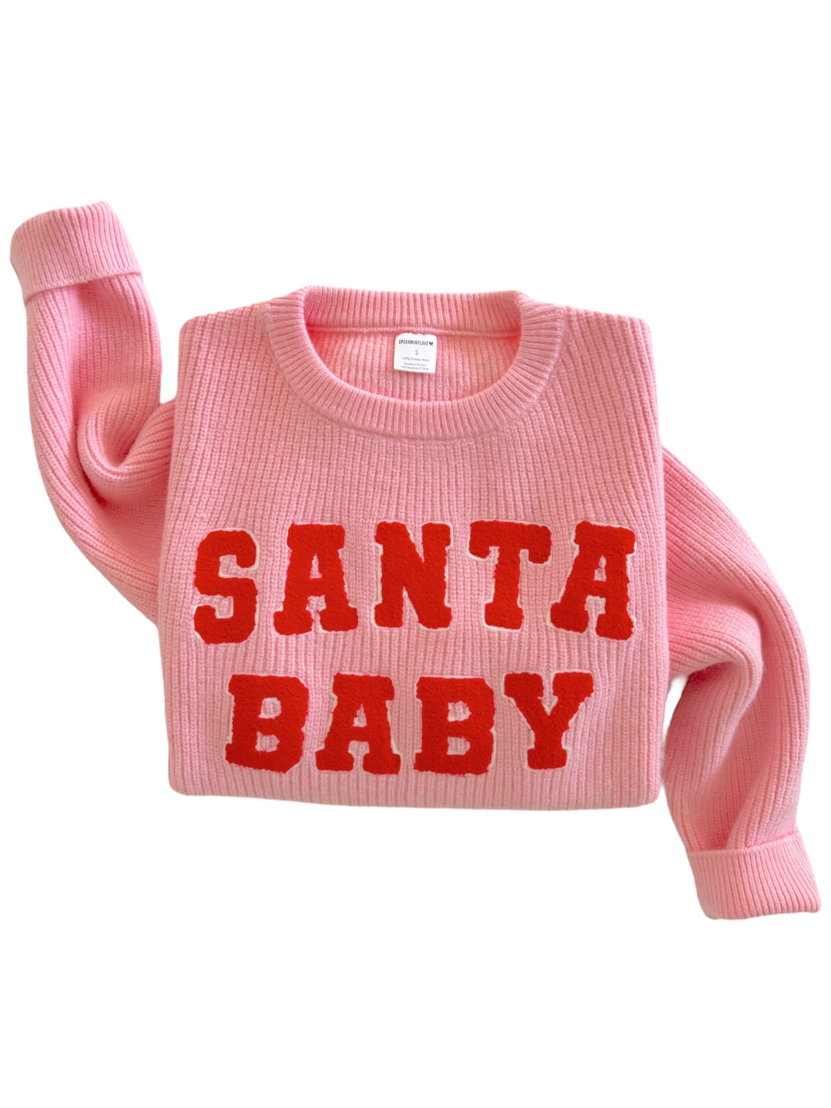 Pink sweater with "SANTA BABY" in bold red letters across the front.