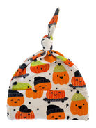 Knotted baby hat with fun cartoon pumpkins in various hats and bright colors on a light background.